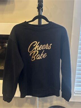 Brunette The Label Black Sweatshirt with Gold 'Cheers Babe' Script